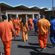 Immigrant detainees walk through the Immigration and Customs Enforcement (ICE), detention facility on February 28, 2013 in Florence, Arizon